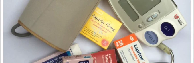 Boxes of medicine including aspirin, and a blood pressure cuff and monitor.