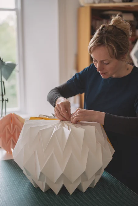Kate Colin in studio making paper folded lampshade