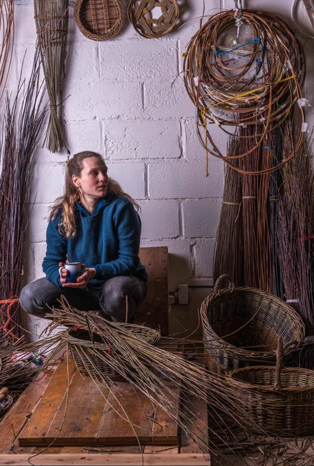 Anna Liebmann in studio with baskets and willow