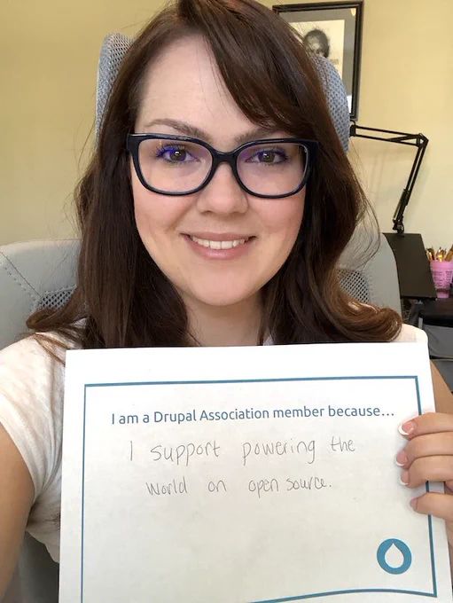 Beverly holds a sign with the quote on why they are a member.