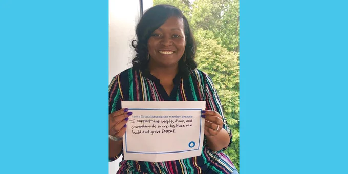 Erica holds a sign with words on why they are a member.
