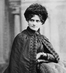 Effie H. Ober in her career years, wearing a dark cape and plumed hat.