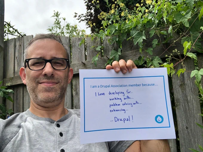 Wil holds a sign with words on why they are a member.
