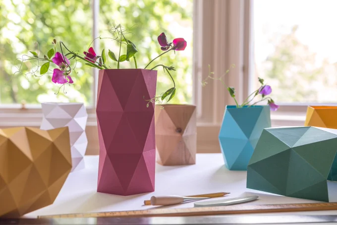 3-dimensional vases with flowers made from folded paper