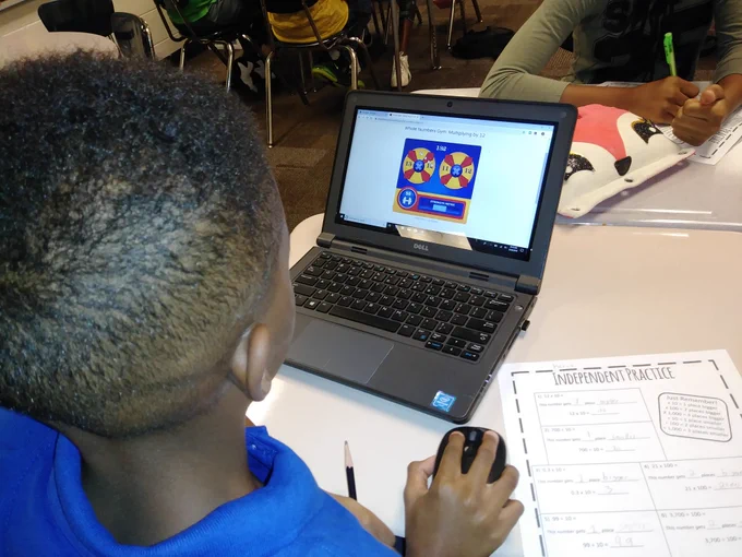 A student is playing a math game on a laptop.