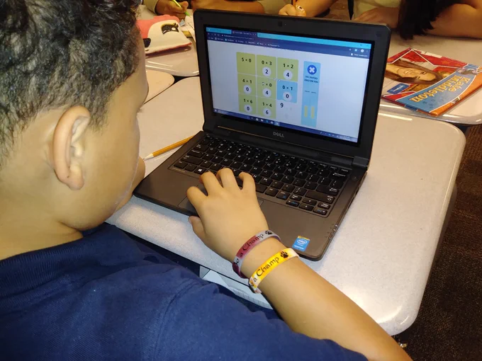 A student is playing a math game on a laptop.