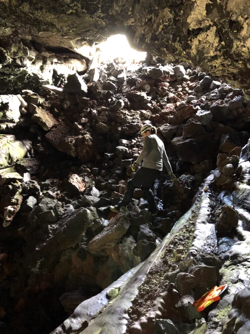 Scientist climbs down into a lava tube