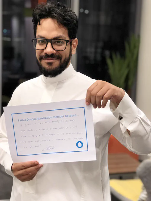 Raed holds sign with words on why they are a member.