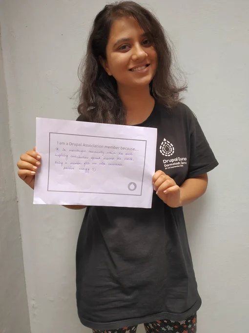 Surabhi holds a sign with words on why they are a member.