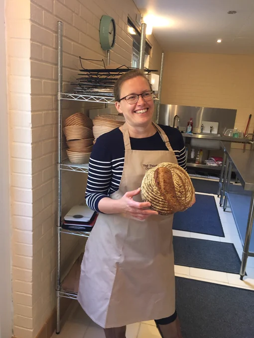 Kath of veg patch kitchen holding a sourdough loaf
