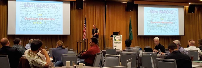 A man on a stage presenting to an audience.