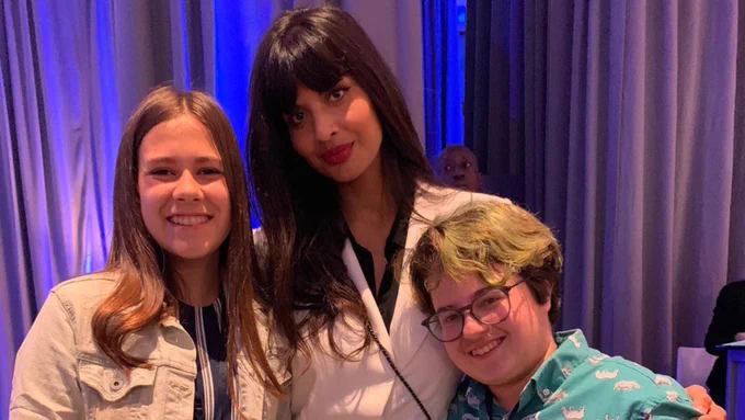 Jordan smiles next to Jameela Jamil and Caleb Tighe.