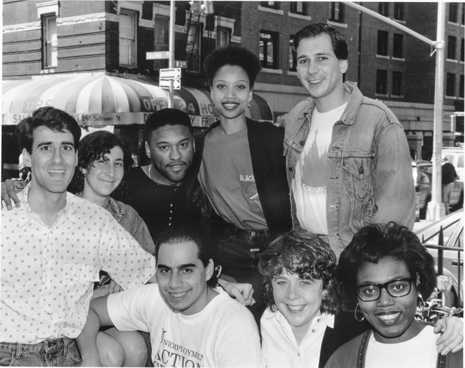 Black and white photo of 7 law students on the corner of West 3rd and Sullivan Street