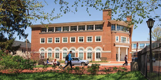 Photo of Alfred Lerner Hall with students walking nearby.
