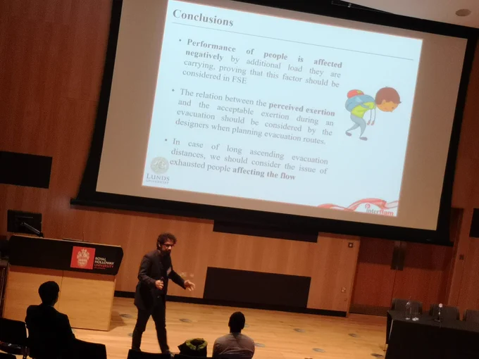 man in front of a powerpoint presentation, with the title 'conclusion'