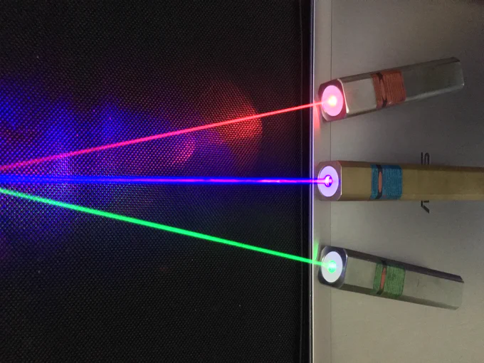 Three different coloured lasers point to the left