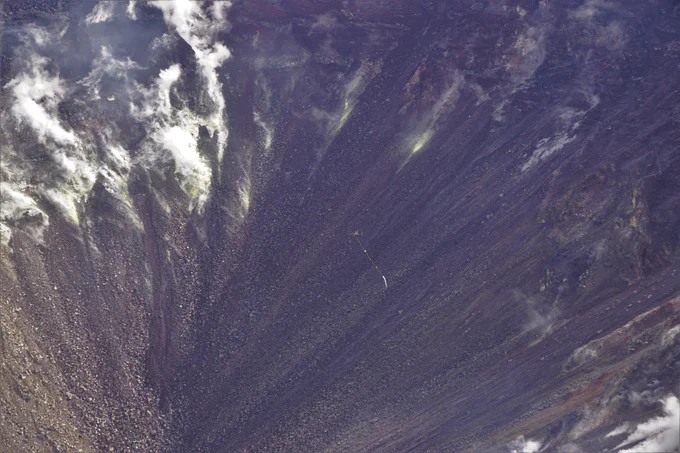 Unmanned aircraft system carrying a container for water in a volcanic crater
