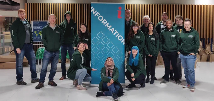 Our army of crew members in front of the info sign