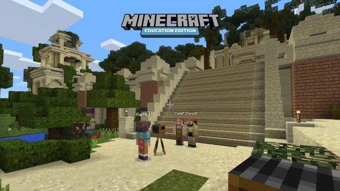 In a Minecraft: Education Edition environment, one character takes a photo with two others in front of a ziggurat. 