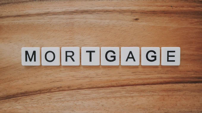 Mortgage scrabble tiles on wooden background. Photo by Precondo CA on Unsplash
