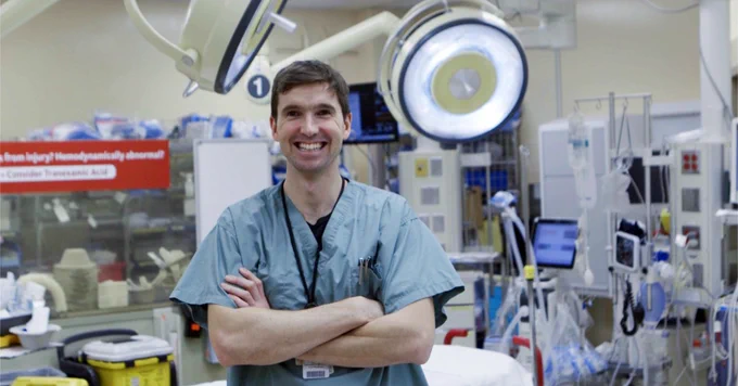 Dr. Andrew Petrosoniak in an operating room setting.