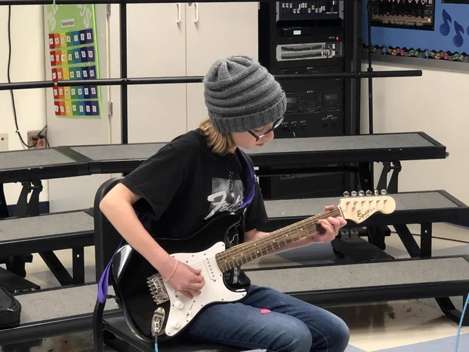 Student playing guitar