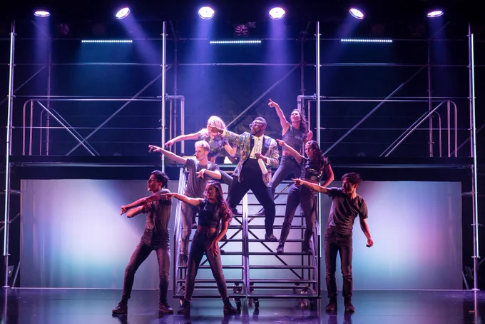 A picture of Zeus (Aadin Church) and the ensemble of Mythic on stairs in the centre of the Segal Centre Stage. Photo Credit Leslie Schachter