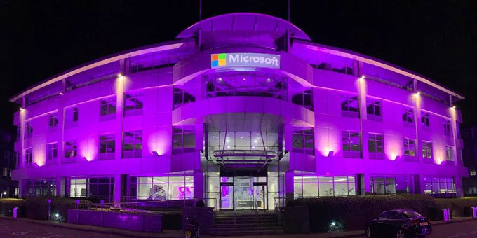 Photography of Microsoft's UK headquarters building in Reading. The building is purple through the use of lights shining onto the building to show support for the Purple Light Up campaign.