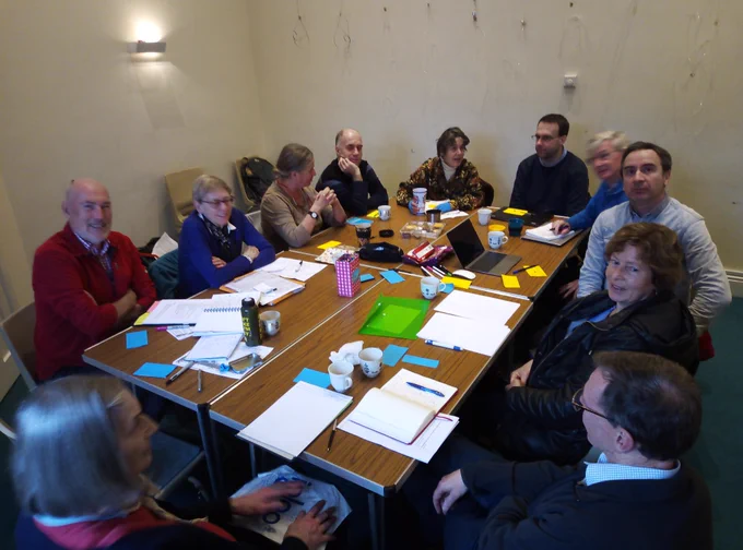 A few of the delegates sat arou d a table discussing ideas.