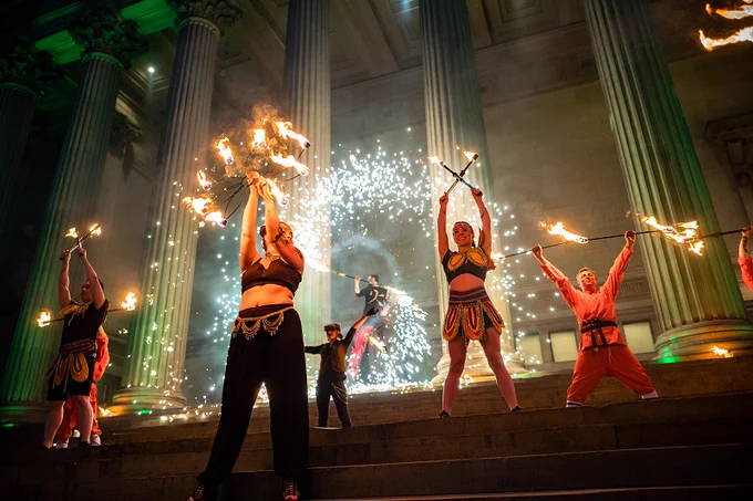 Fire dancers on the steps of a museum