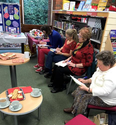 Volunteers from the Littlehampton Cluster, gathered at Rustington Library taking part in a quiz hosted by library staff.