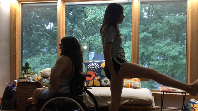 Anaiss faces to the left and Jordan faces to the right with her leg up.