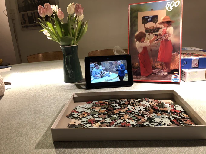 A vase of pink tulips, a box of puzzle Pieces and an iPad showing people baking ❤️
