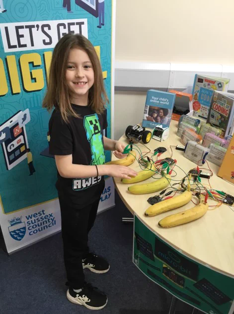 Girl playing the musical bananas at Bognor Raspberry Jam coding event