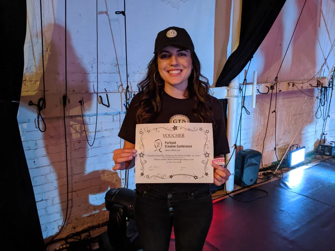 Lauren holding voucher for Cre8con ticket