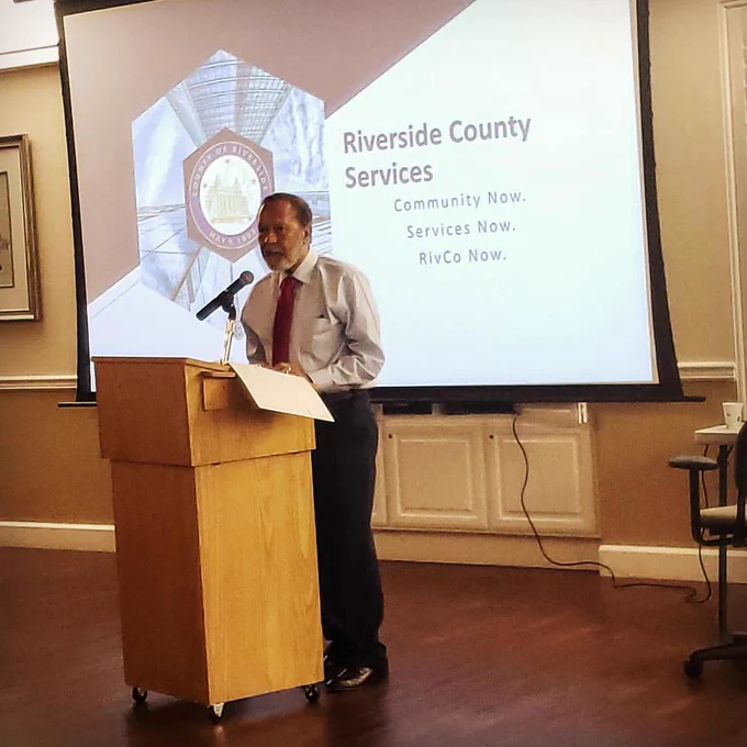 Supervisor Washington speaks at a podium indoors.