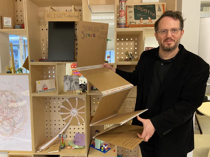 David Alsdorf holding a conceptual many layered map