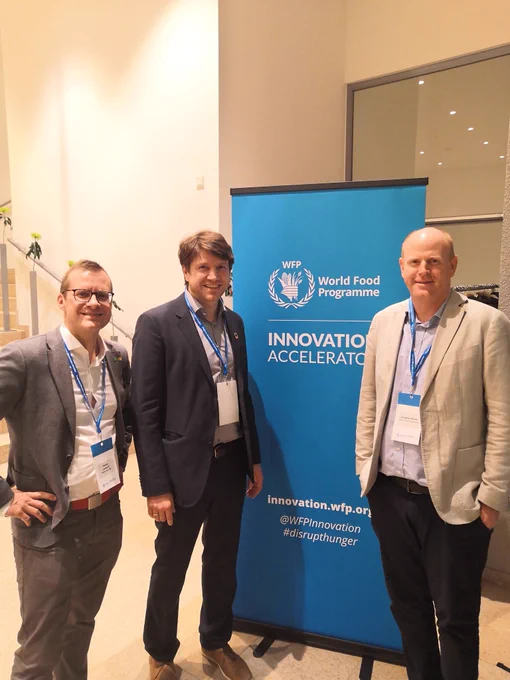 3 men talking to each other: Florian Landorff, Welthungerhilfe Head of Innovation, Markus Matiaschek, Welthungerhilfe Child Growth Monitor, J. Rivers, WFP.