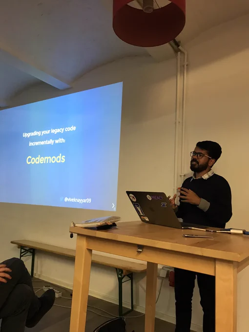 Vivek presenting in front of his title slide.