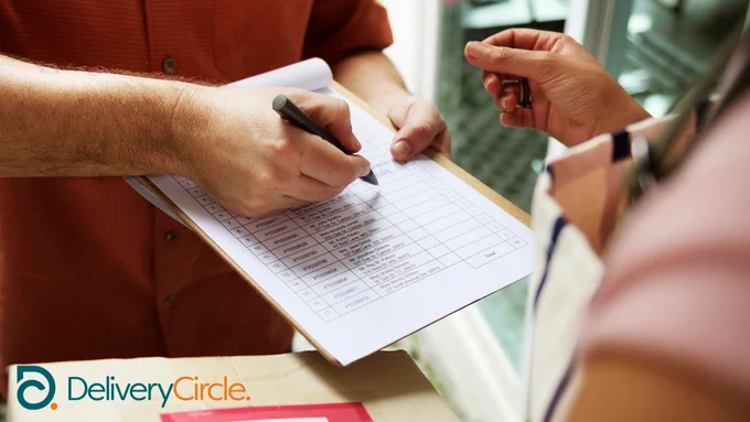 delivery man holding out clipboard for a signature