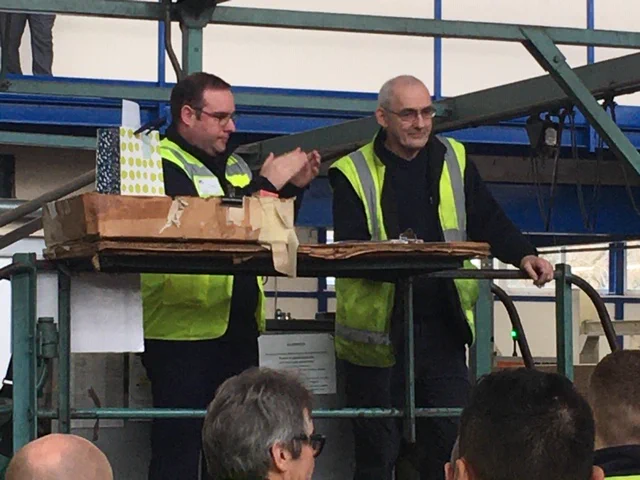 Gavin Peters CEO Tri Wall UK presenting Derek Long a thank you gift for 50 years of service with Tri Wall Monmouth