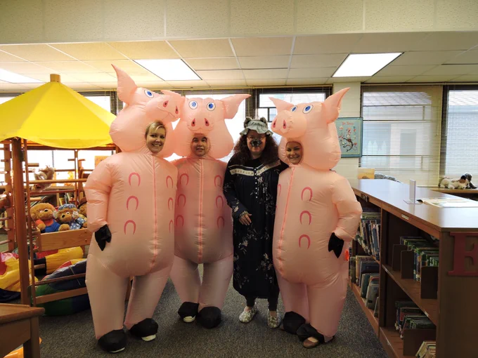 Teachers and the media specialist dress as the three little pigs at Farmer Elementary School.