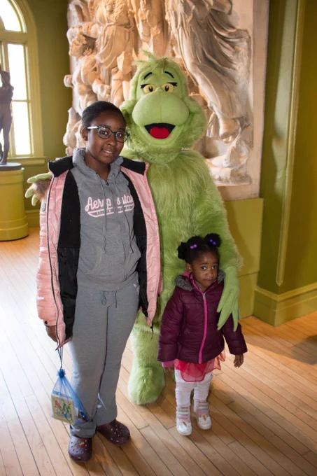 Two girls pose with the Grinch in the Plaster Cast Gallery of the George Walter Vincent Smith Art Museum.