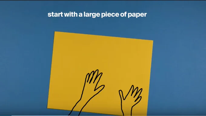 Still from a MetKids video explaining how to make origami.