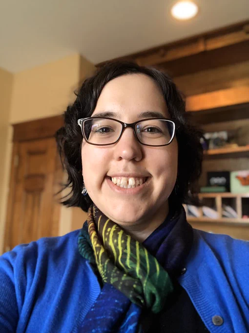 Liz in blue sweater with a multicolored scarf