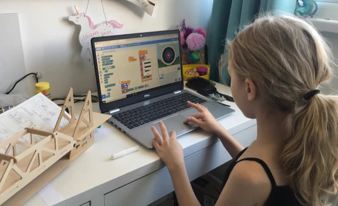 A girl engaging in digital making at home using Scratch