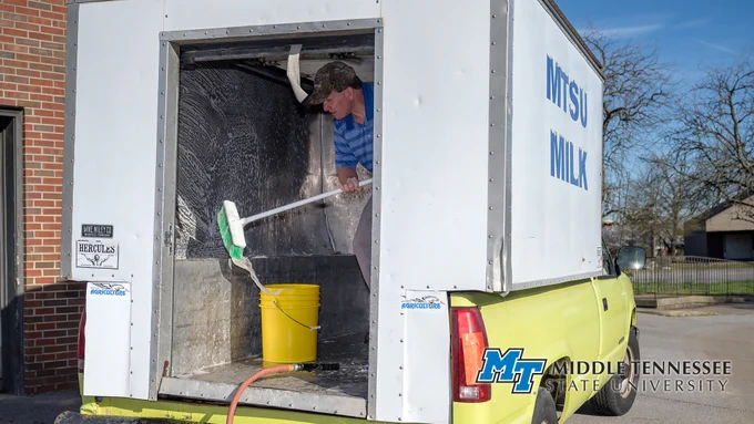 Steve Dixson cleans the cooler in one of the MTSU Creamery delivery trucks March 26 to prepare for another shipment of fresh MTSU milk to local businesses and schools. MTSU's herd of Jerseys and Holsteins are milked daily by School of Agriculture students and staffers, and the milk is processed and bottled on campus under state-mandated sterile conditions, amid the COVID-19 crisis. ((MTSU photo by J. Intintoli))