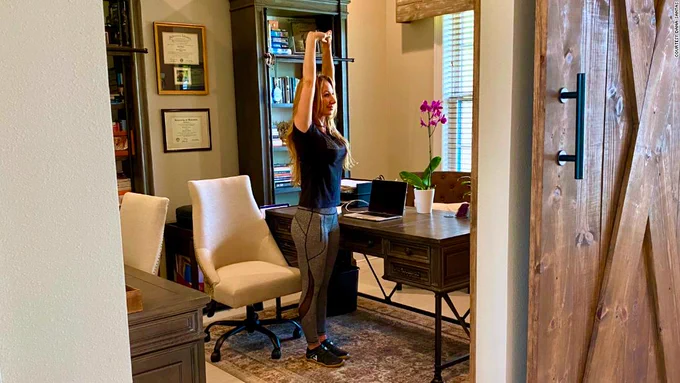 Photo of person stretching near their desk