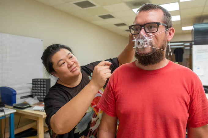 Anna Wan, assistant professor of math licensure at the University of Southern Mississippi, tests a medical mask prototype 3D printed by her “Eagle Maker Hub” in Hattiesburg.