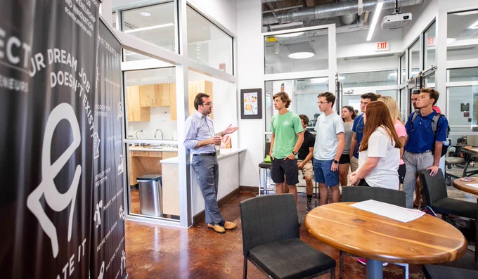 Eric Hill, director of MSU's Center for Entrepreneurship and Outreach (CEO), leads a tour of the center's McCool Hall facility for students in the College of Business' MBA Venture Pathway program. 